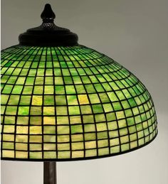 a green stained glass lamp on a table