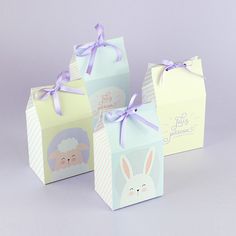 three small gift bags with bunny ears on them