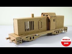 a cardboard train is sitting on the tracks