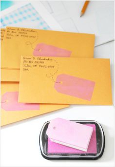 some pink and yellow envelopes are next to each other