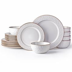 a stack of white and gold dinnerware