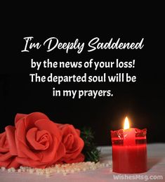 a candle and some red roses on a white tablecloth with pearls in the foreground