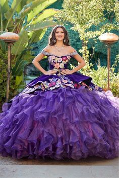 a woman in a purple dress posing for a photo