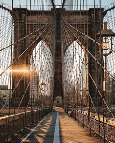 the sun shines through the windows of an old, rusty bridge in new york city