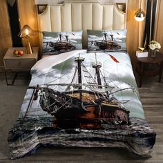 a bed with a pirate ship in the ocean on it's cover and pillow cases