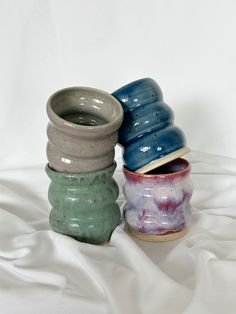 three ceramic vases stacked on top of each other