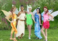 four women dressed in fairy costumes posing for the camera