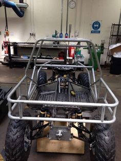 an off road vehicle is parked in a garage