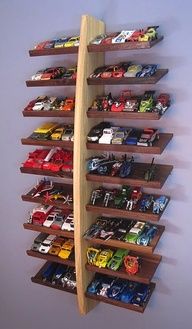 a wooden shelf with toy cars on it