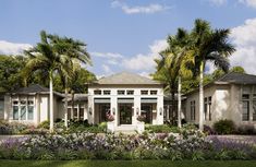 a large white house surrounded by palm trees