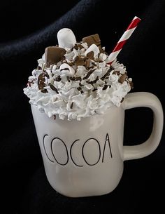 a white coffee cup filled with chocolate and marshmallows