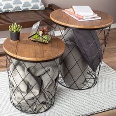 two tables sitting on top of a wooden floor next to a bench with books and plants