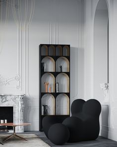 a living room filled with furniture and a fire place next to a book shelf in front of a fireplace