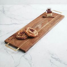 two donuts on a wooden cutting board with honey