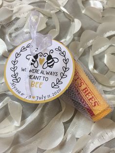 a stick of bees is on top of some white fabric with silver foil around it