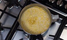 a pot filled with liquid sitting on top of an oven burner next to a stove