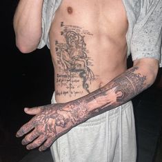 a man with tattoos on his arm and hand