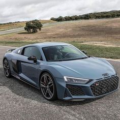 an audi sports car is parked on the side of the road