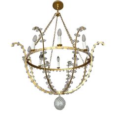 a chandelier with candles hanging from it's center and chain around the lights