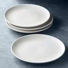 three white plates stacked on top of each other