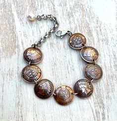 "THIS ITEM IS IN STOCK AND SHIPS  VIA USPS MAIL AMERICAN HERITAGE COLLECTION Indian Head Penny- minted 1859-1909 The perfect gift for any one who loves American history or vintage coins! This is a lovely bracelet made with 8 domed and polished Indian Head pennies. Made with alternating heads and tails (because the back is just as beautiful as the front). The pennies are connected with stainless steel links. It closes with a stainless steel lobster claw clasp and is finished with a freshwater pea Heirloom Medallion Stamped Jewelry, Antique Nickel-free Bracelet, Antique Adjustable Jubilee Bracelet, Heirloom Bracelet Collectible Jewelry, Heirloom Collectible Bracelet Jewelry, Heirloom Style Collectible Bronze Jewelry, Engraved Heirloom Metal Jewelry, Engraved Copper Bracelet Jewelry, Heirloom Bronze Jewelry For Collectors