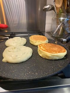 three pancakes are being cooked on the stove