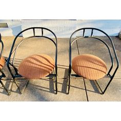 three chairs sitting next to each other on the sidewalk