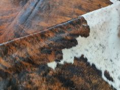 a cow hide with brown and white spots on it