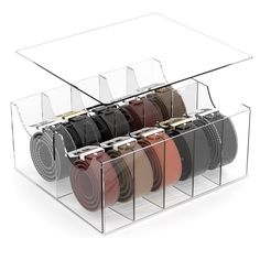 an acrylic display case holds several pairs of belts in various colors and sizes