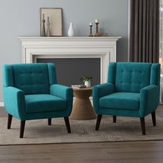 two blue chairs sitting in front of a fireplace