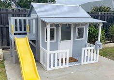 a child's play house with a yellow slide