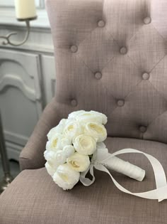 a bridal bouquet sitting on top of a chair