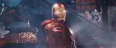 the iron man standing in front of a fire