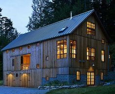 a large wooden building with lots of windows on it's sides and lights in the windows