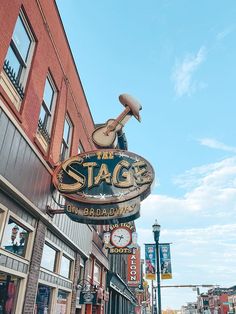 the sign for the stage is hanging on the side of the building in front of it