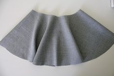 a gray skirt hanging on the wall