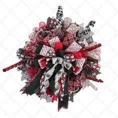 a close up of a red, white and black bow with candy canes on it