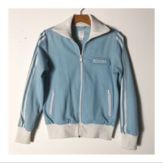 This Vintage Adidas Track Jacket Is Something Special. It Has Velcro On The Front Placket With The Adidas Flower!!! This One Is “Rare” And So Good! It’s Baby Blue In Color With White Stripes And In Stellar Condition. White Adidas Jacket, Adidas Track Jacket, Adidas Jackets, Adidas Track, Vintage Adidas, Blue Adidas, White Adidas, Track Jacket, Track Jackets