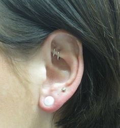 a woman with two piercings on her ear