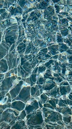 the water is reflecting sunlight and ripples on it's surface, as seen from above