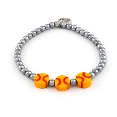 an orange and silver beaded bracelet with two baseballs on it