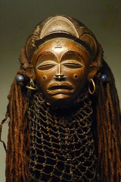 an african mask with braids on display