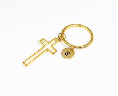 a gold keychain with a cross on it