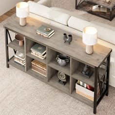 a living room with a couch, coffee table and bookshelf on the floor