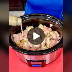 a slow cooker filled with meat and vegetables being poured into the crock pot