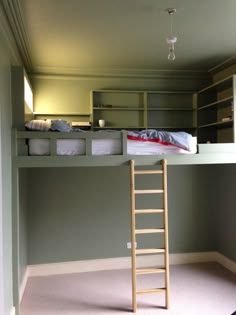 a ladder is in the middle of a room that has bunk beds on each side