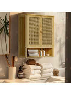 a wooden cabinet with towels stacked on top of it