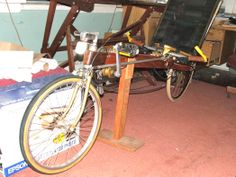 a bicycle parked next to a desk with a chalkboard on it's back