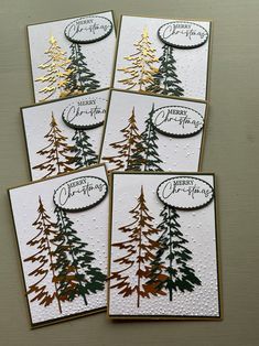 four christmas cards with pine trees on them