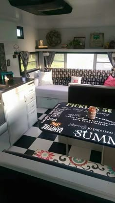 a kitchen with black and white checkered flooring next to a stove top oven